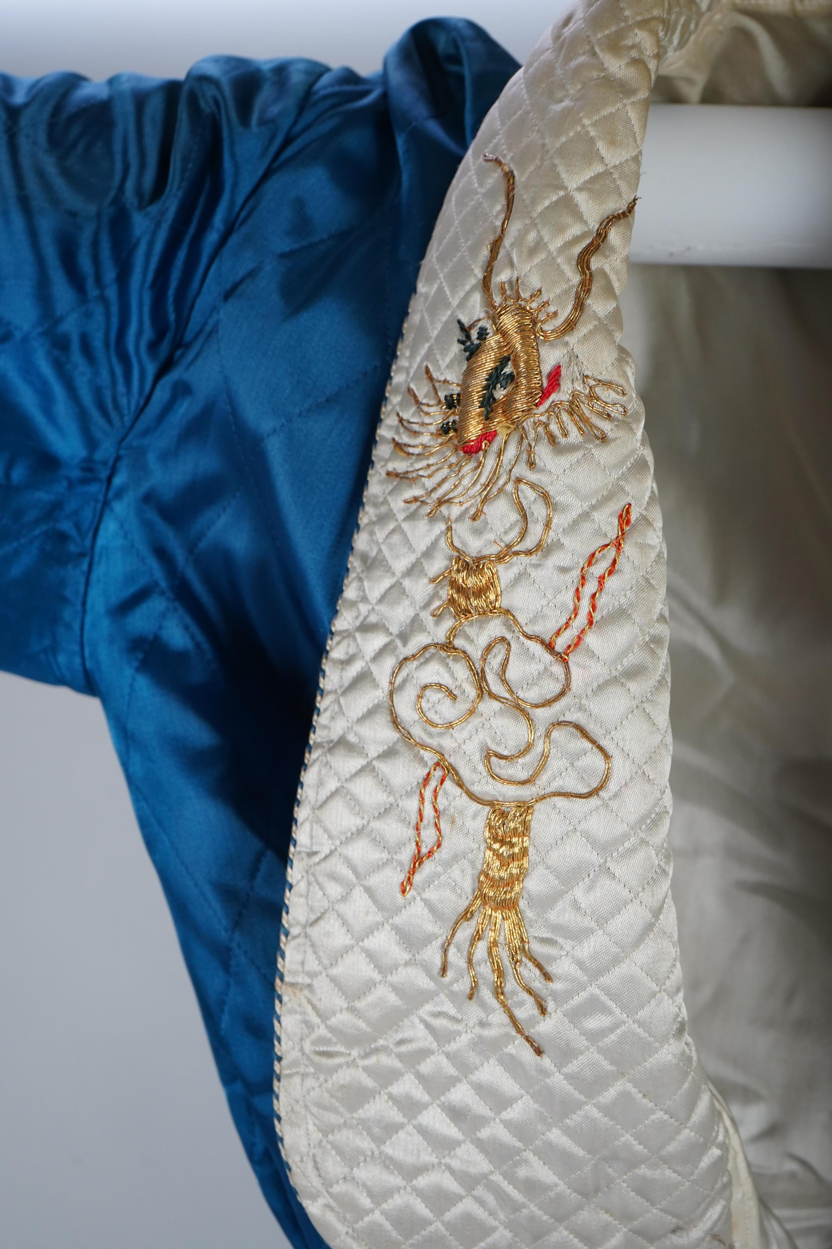 A mid 20th century Royal blue satin gentleman’s smoking jacket and matching dressing gown with Chinese gold dragon embroidery to both the quilted collars and cuffs, measurement from top back of collar to bottom of dressi